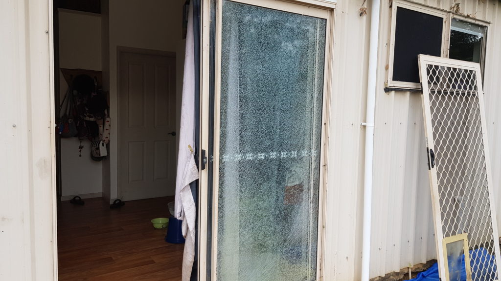 Fixed sliding door glass shattered by a stone